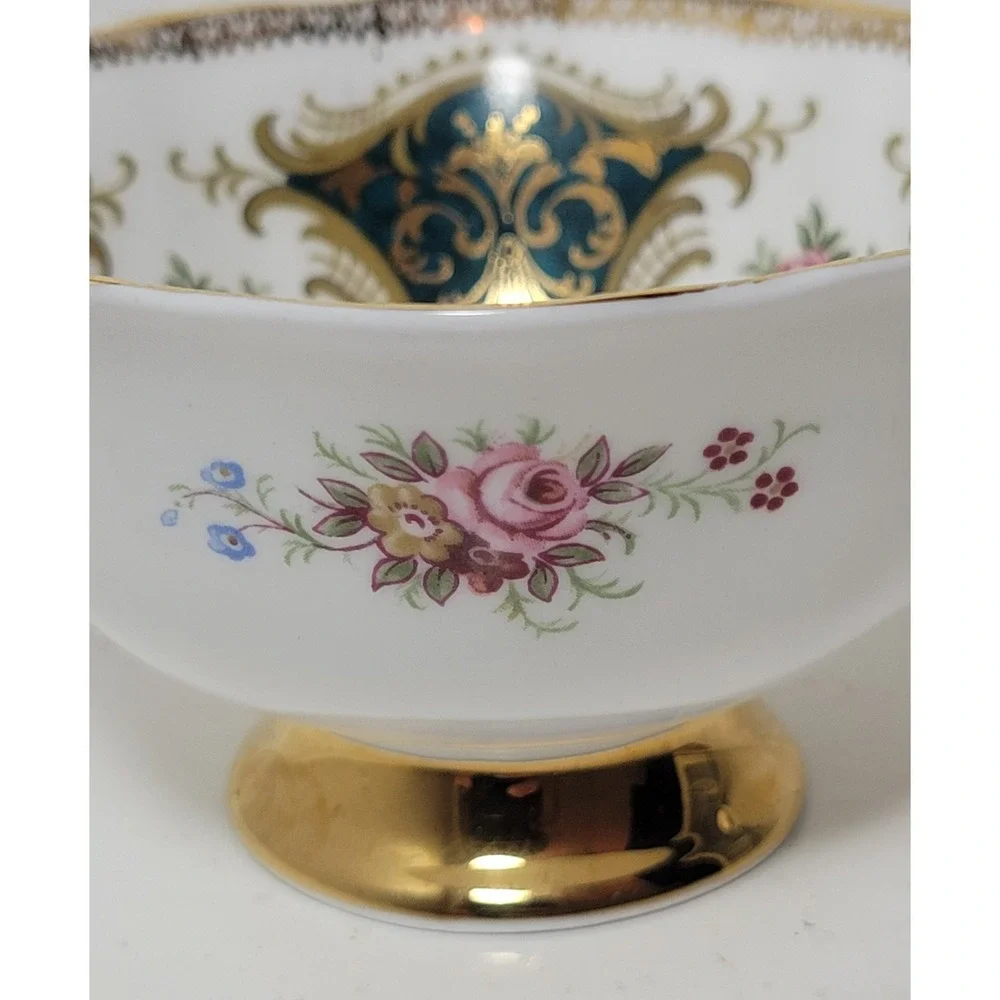 Paragon teacup - dark green panels on white background with floral‎ decor...Read